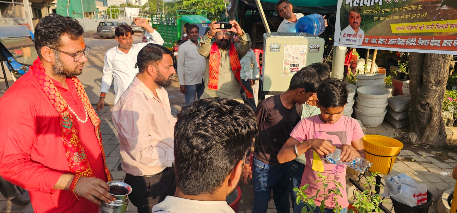 मीठे शरबत का वितरण करते मदन मोहन शर्मा और उनकी टीम