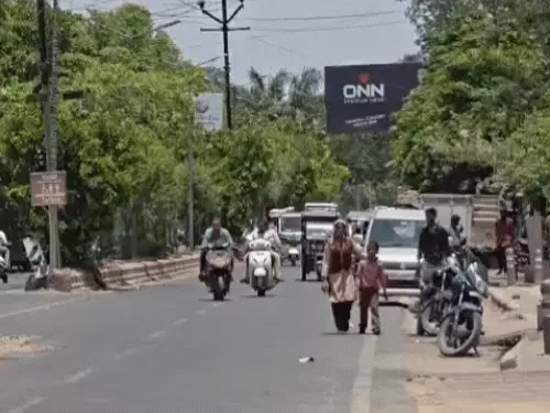 Agra Municipal Corporation water sprinklers spraying water on main roads to reduce heatwave impact