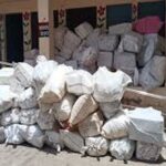 department officials inspecting seized medical stocks inside a warehouse layout