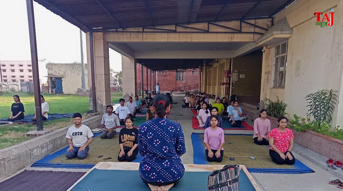 Medical college faculty and nursing staff doing pranayam breathing practice sessions inside an auditorium review setup.