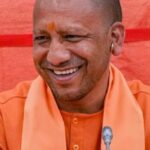 Chief Minister Yogi Adityanath smiling and sharing light hearted humorous moments with public representatives inside Mandalayukt Sabhagar Agra